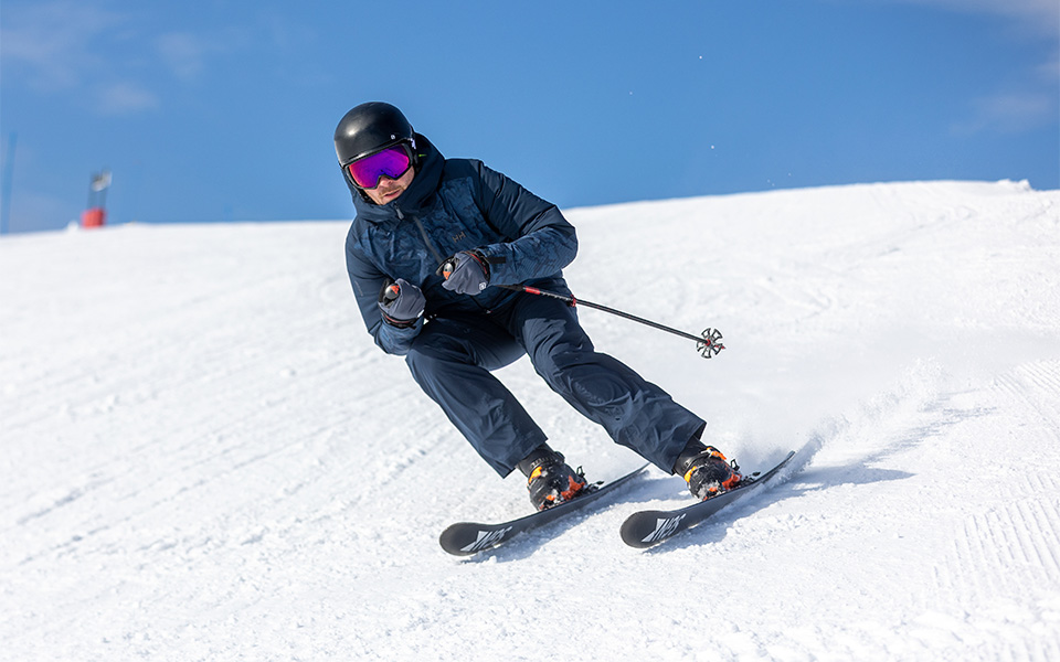 A man skiing in Helly Hansen ski clothing