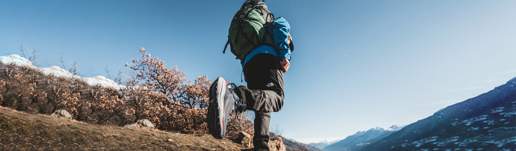 man walking trail path wearing The North Face clothing