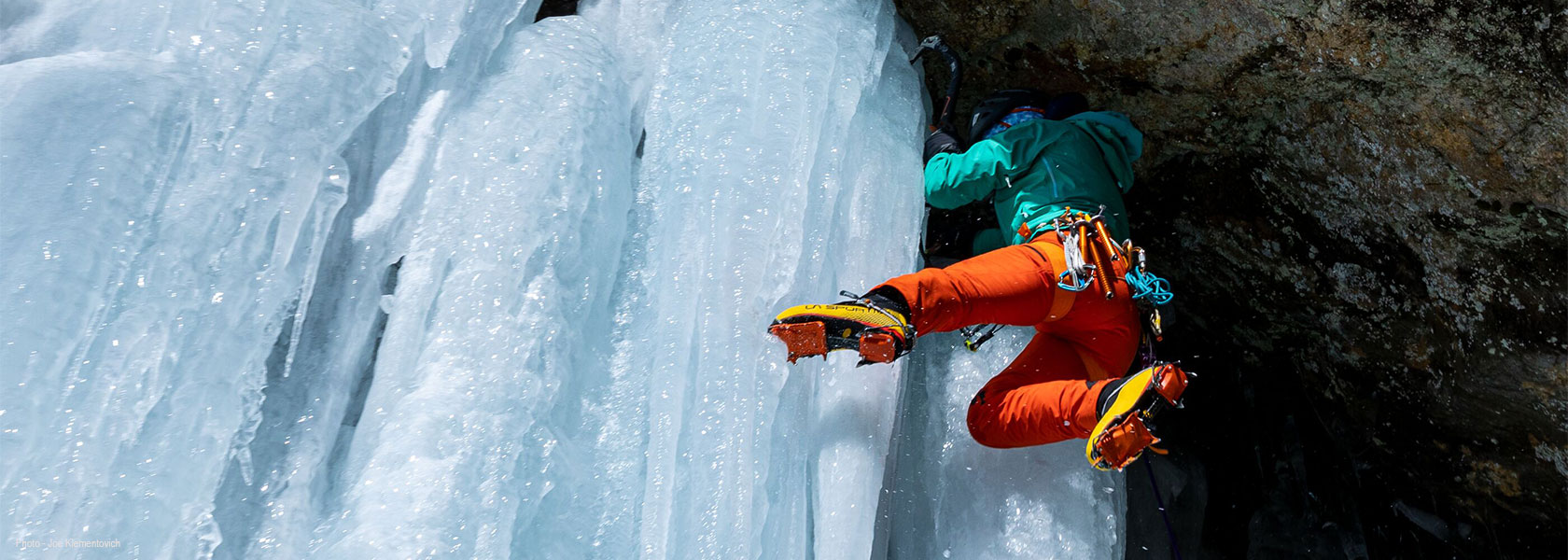 A person is mountaineering on ice, wearing Patagonia kit.