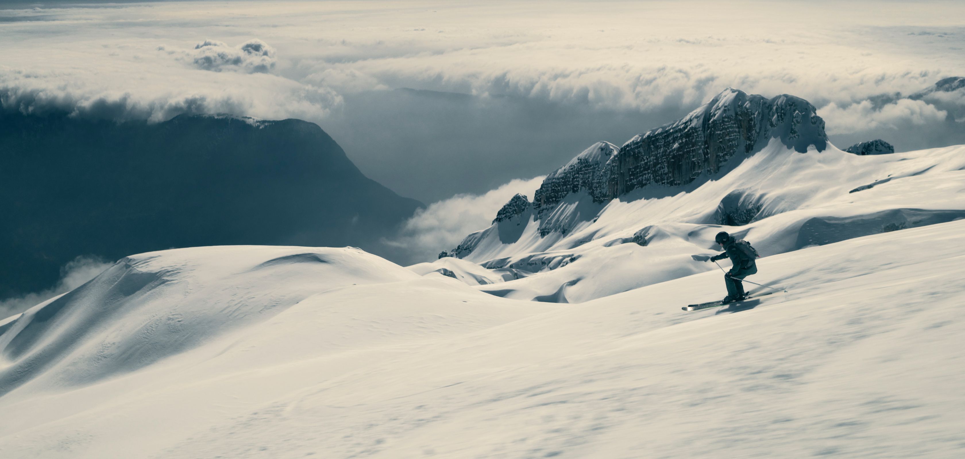 A person skiing to the side on a mountain face