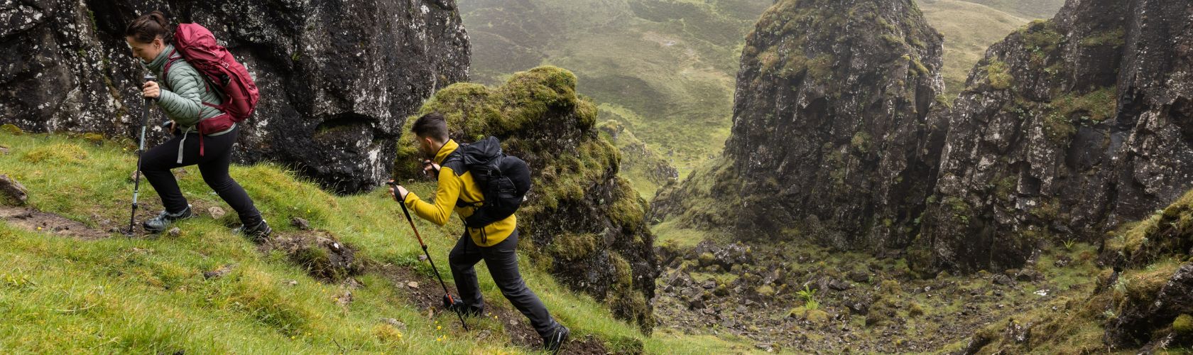 A man and a woman on a hike wearing rucksacks 