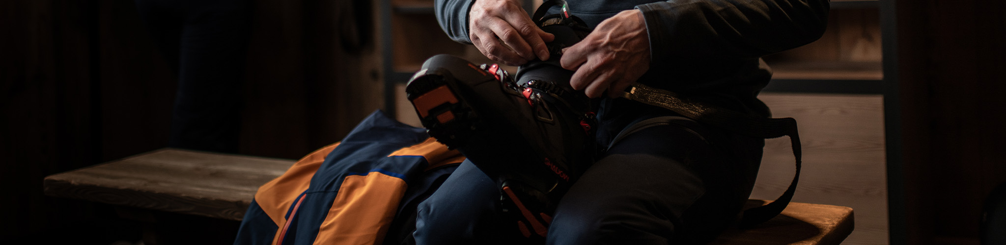 A person is putting a ski boot on