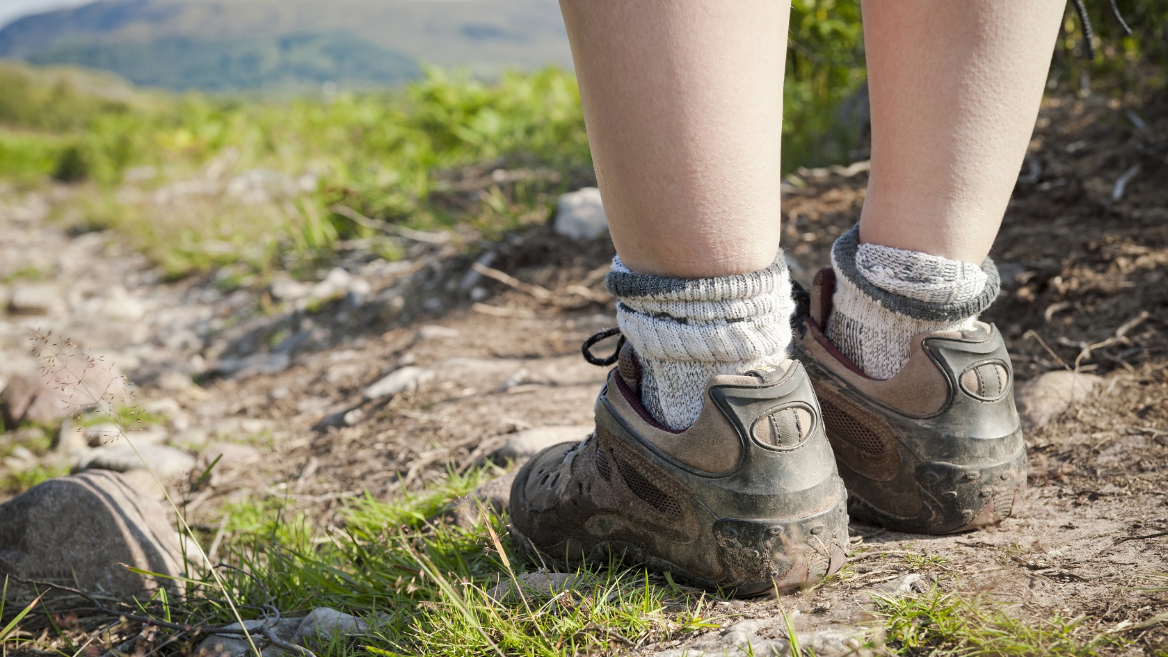 A person on a walk in their walking shoes