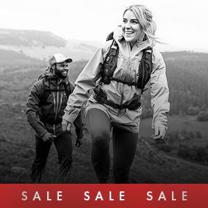 Shop climbing sale. A man climbing in climbing gear on a side of a rock. 