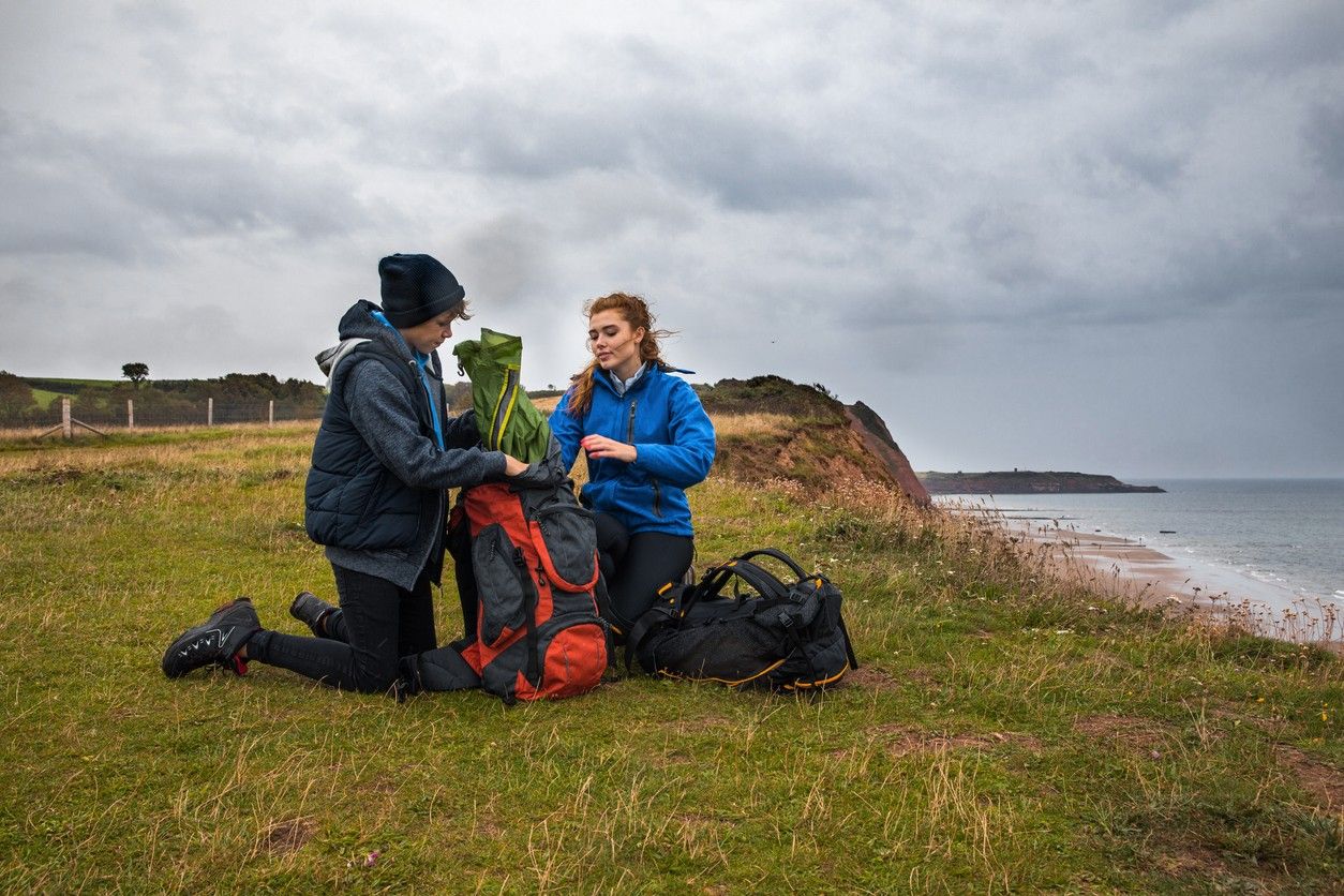 Young people setting up their tent