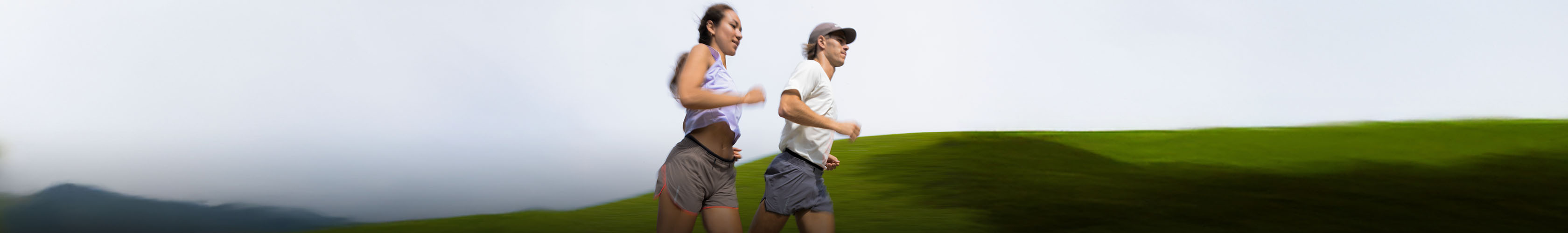 Shop Clothing new season. A man and woman running on the road