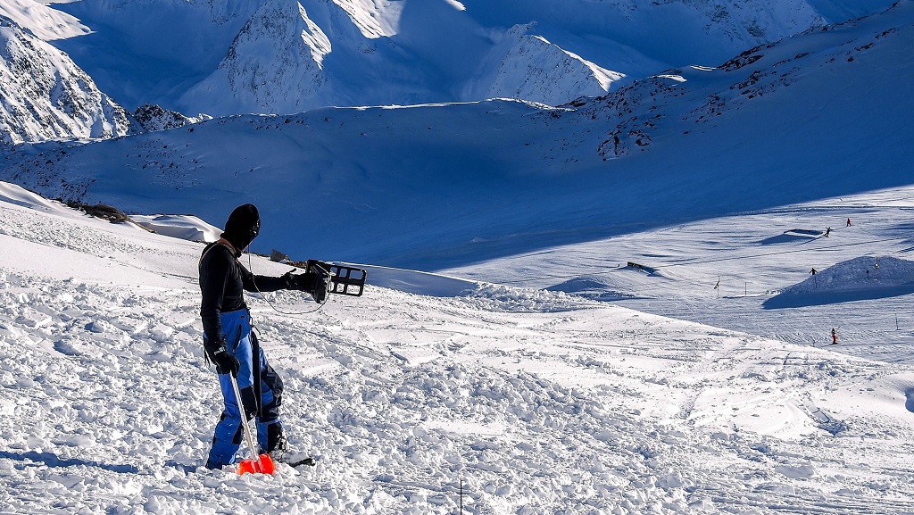 A person using avalance safety equipment 