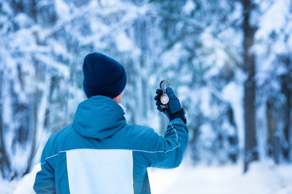 A man checking his compass on a walk 
