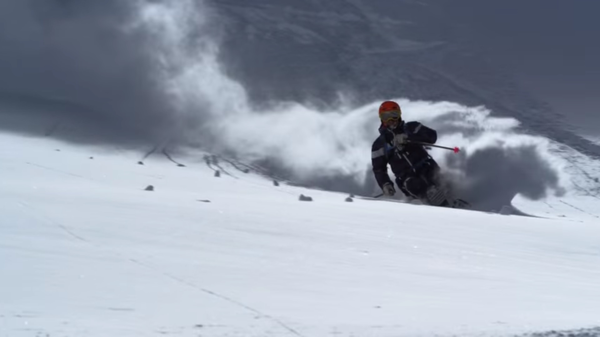 A person skiing through powder 