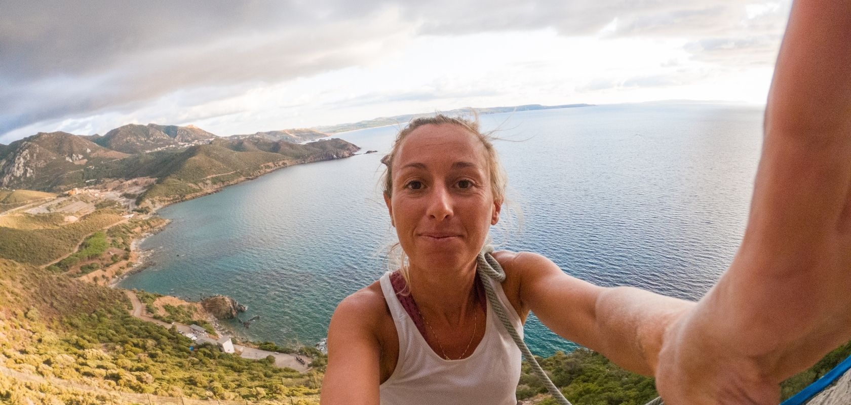 A person sports climbing by the sea 