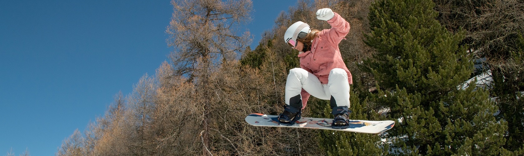 A snowboarder catching air