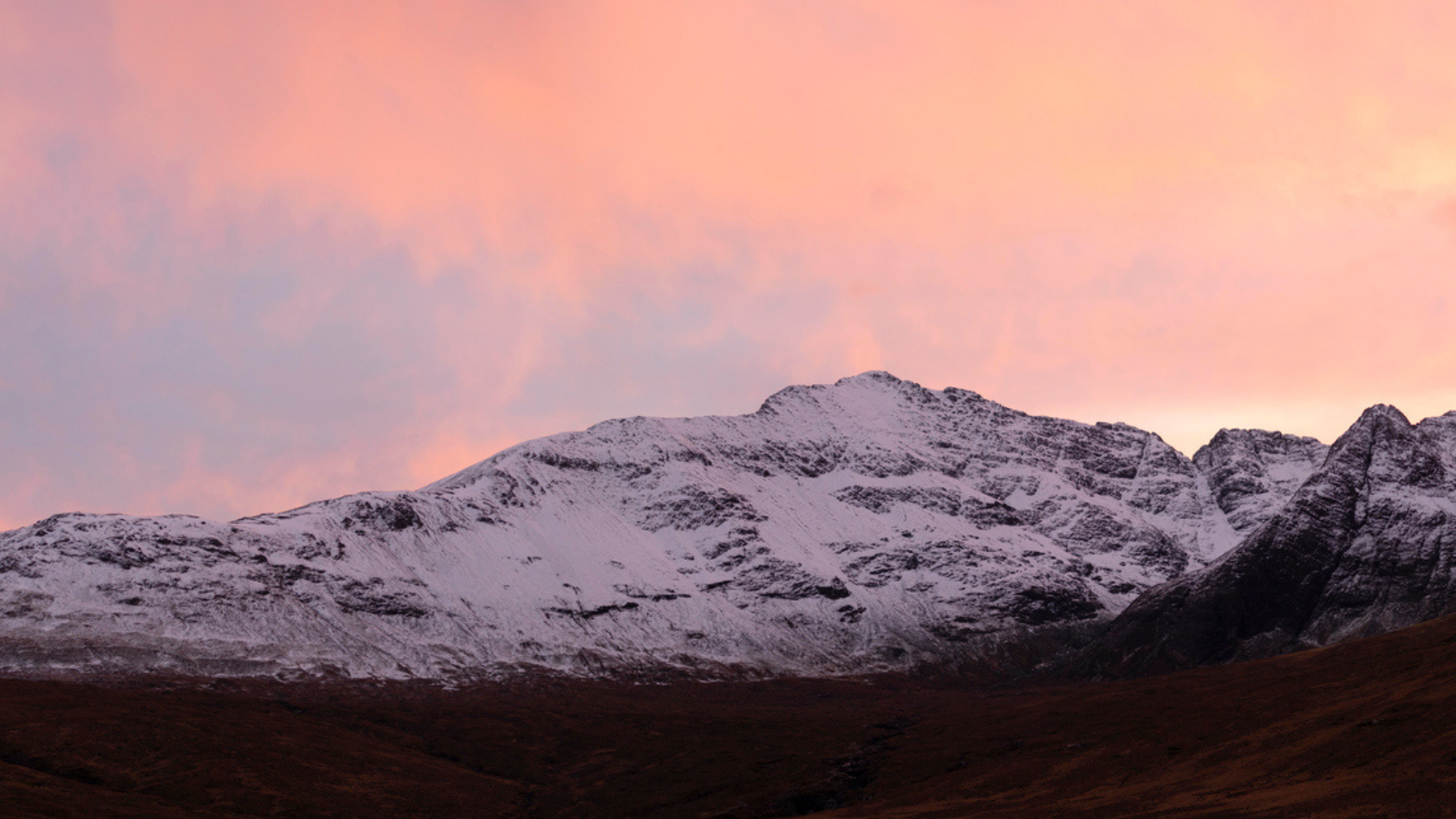 The sun rising over the Scottish mountains in the winter 