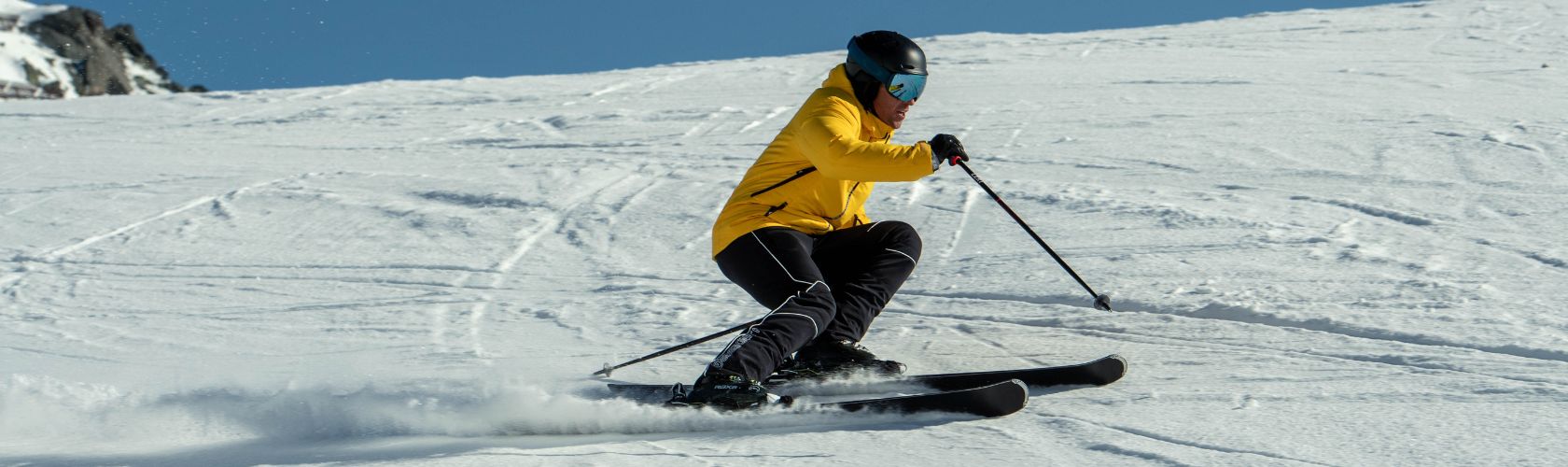 A man skiing in black ski pants 