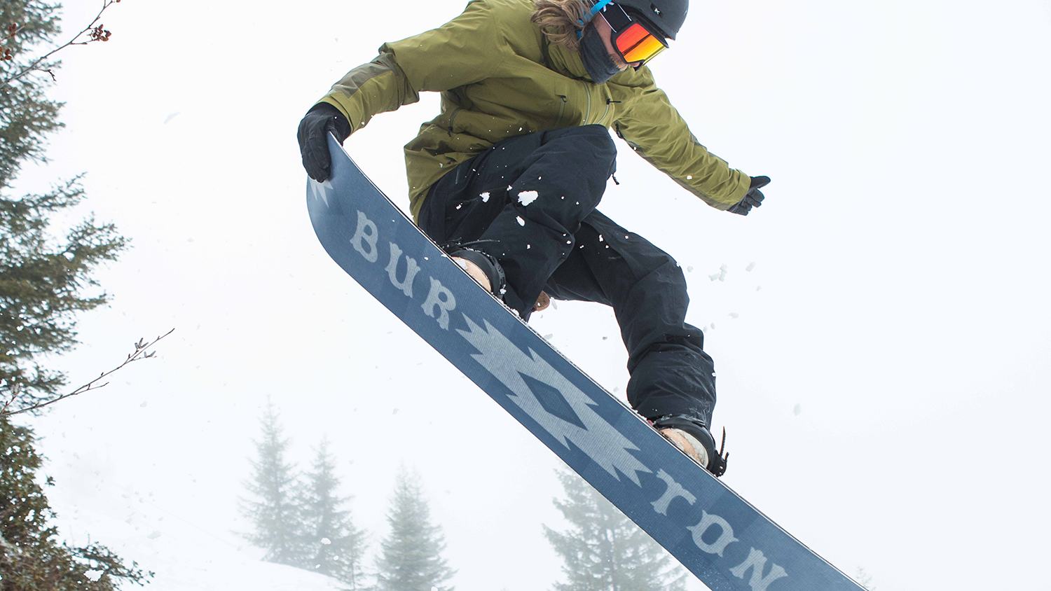 A person snowboarding in Burton snowsports clothing 