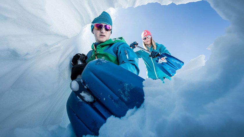 People using avalanche safety shovels 