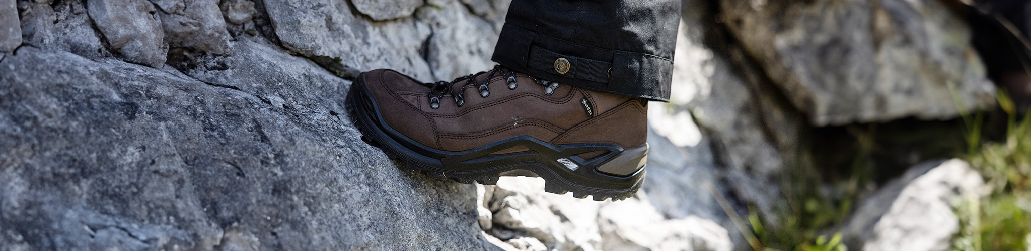 Shop footwear new season. A person wearing walking boots 