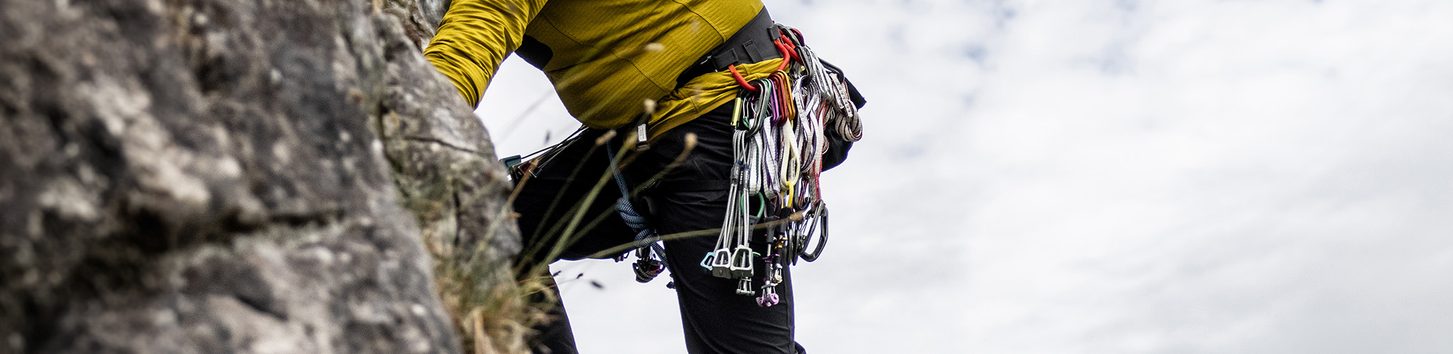 Shop harnesses. A man wearing a climbing harness