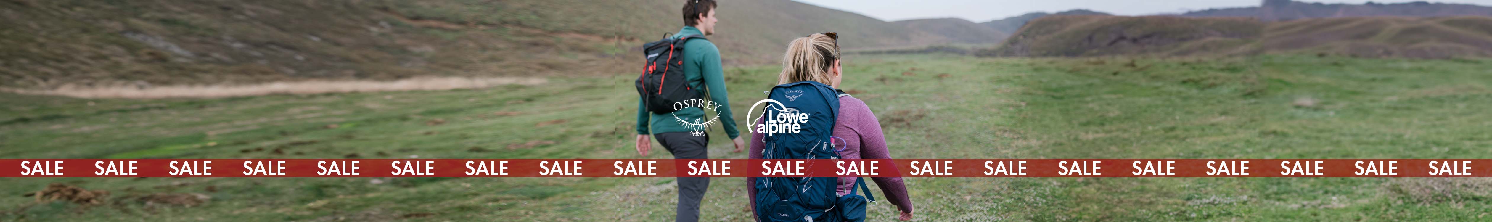 Packs & Luggage sale. Two people are hiking, wearing backpacks.
