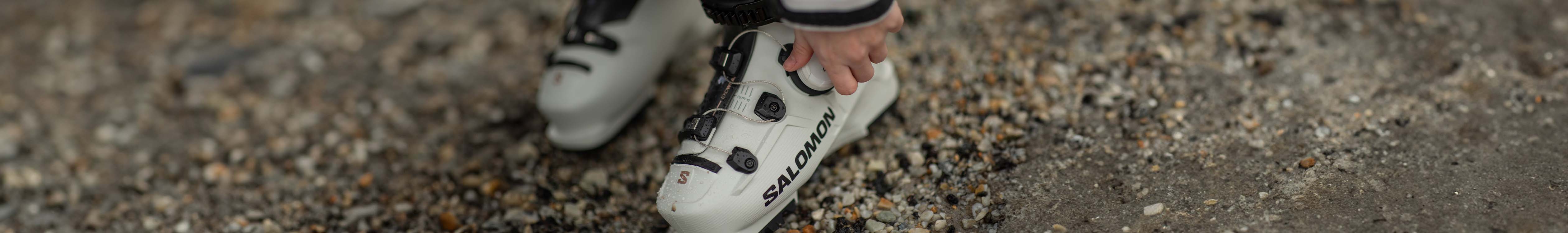 Shop ski boots. A skier adjusting ski boots