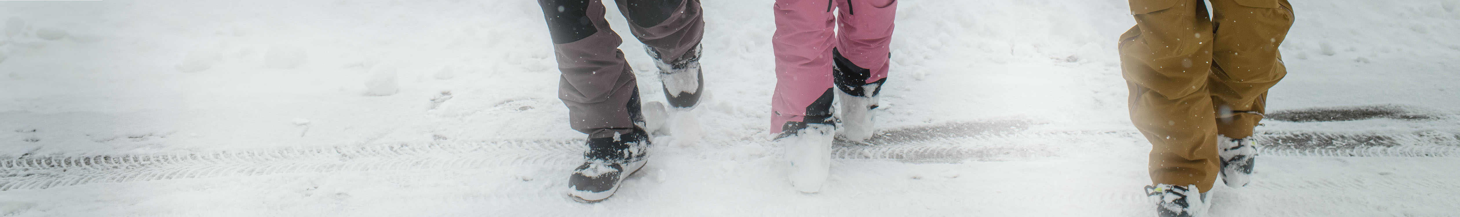 Shop Snowboard boots. People walking in the snow wearing snowboard boots. 