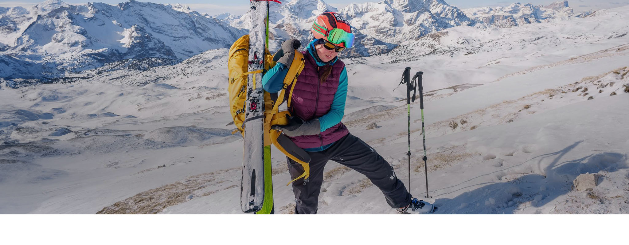 A woman carrying her skis with ski luggages