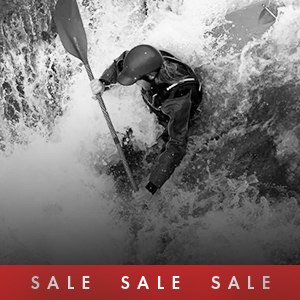 Shop climbing sale. A man climbing in climbing gear on a side of a rock. 