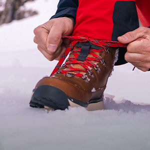 Shop Footwear new season. Person adjusting snow boot
