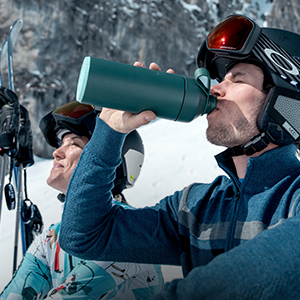 Shop scessories new snowsport season . A skiier having a dring of water