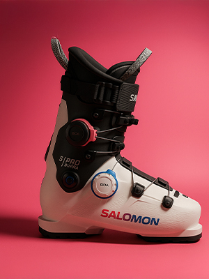 Shop ski footwear. A salomon ski boot on pink background