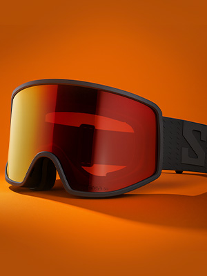 Shop ski goggles. A pair of ski goggles with orange lense on orange background
