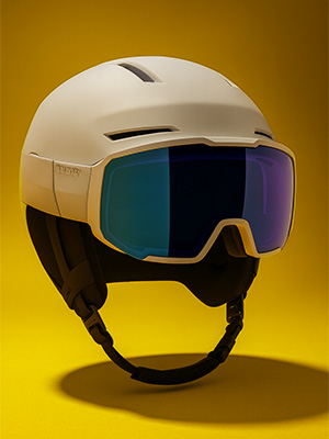 Shop ski helmets. A ski helmet with goggles on yellow background