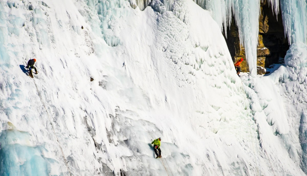 People ice climbing 