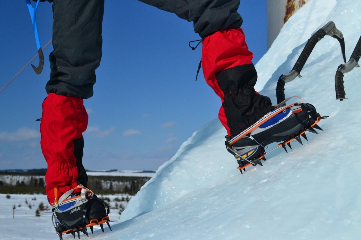 A person wearing crampons when ice climbing 