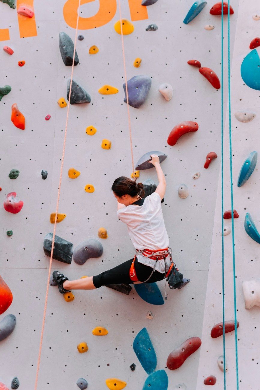 A person climbing an indoor climbing wall 