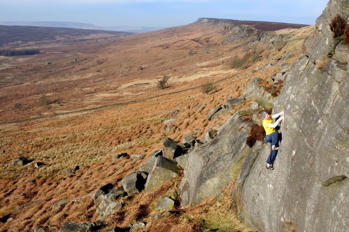 A man climbing stanage edge 