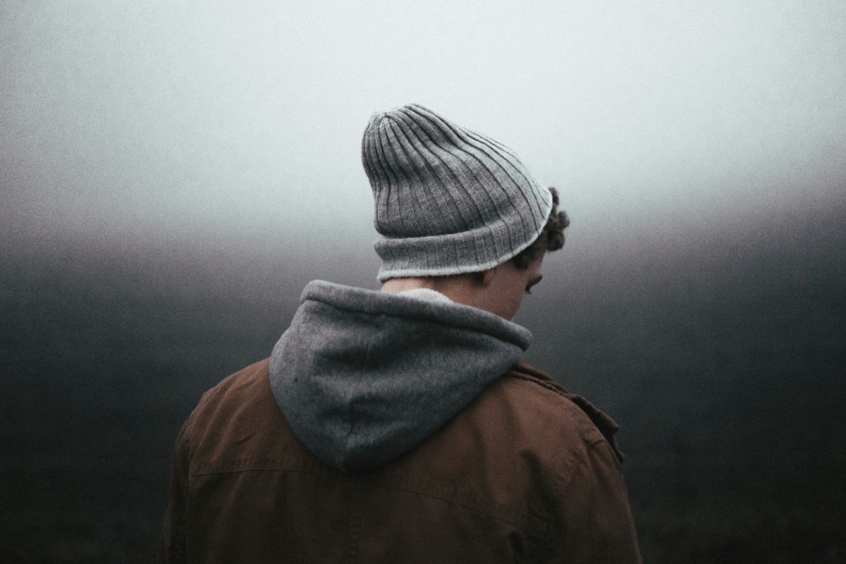 A man wearing a grey beanie hat 