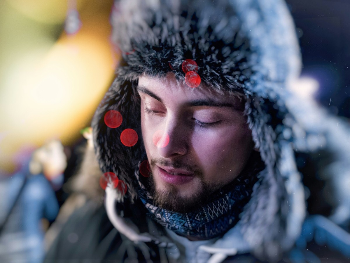 A man wearing a furry hat with ear flaps