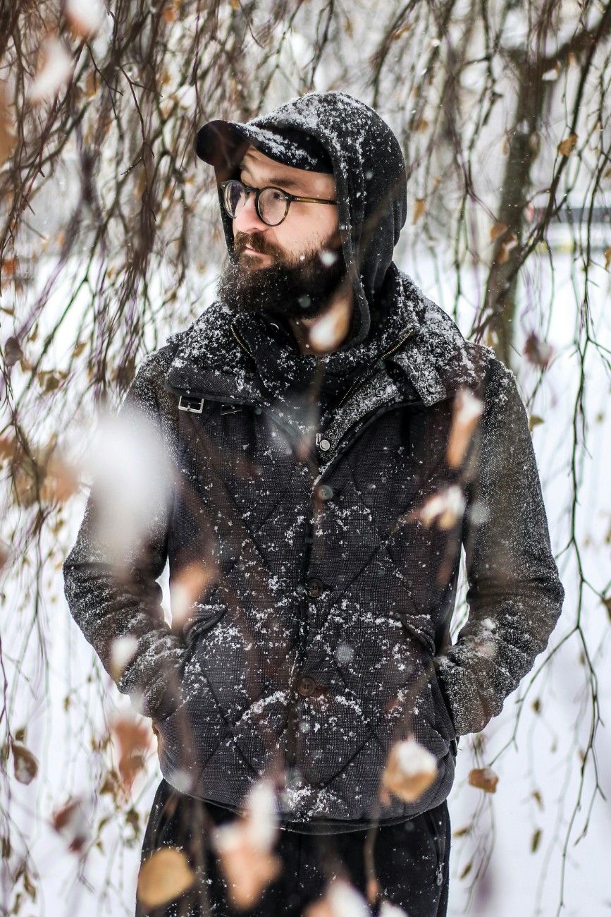 A man wearing a cap in a winter landscape