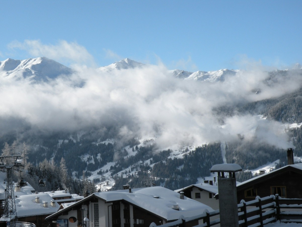 Verbier ski resort from above, with clouds over the Swiss Alps 