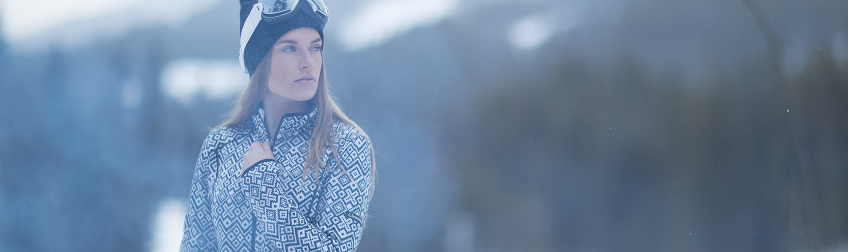 A woman wearing a fleece in the mountains 