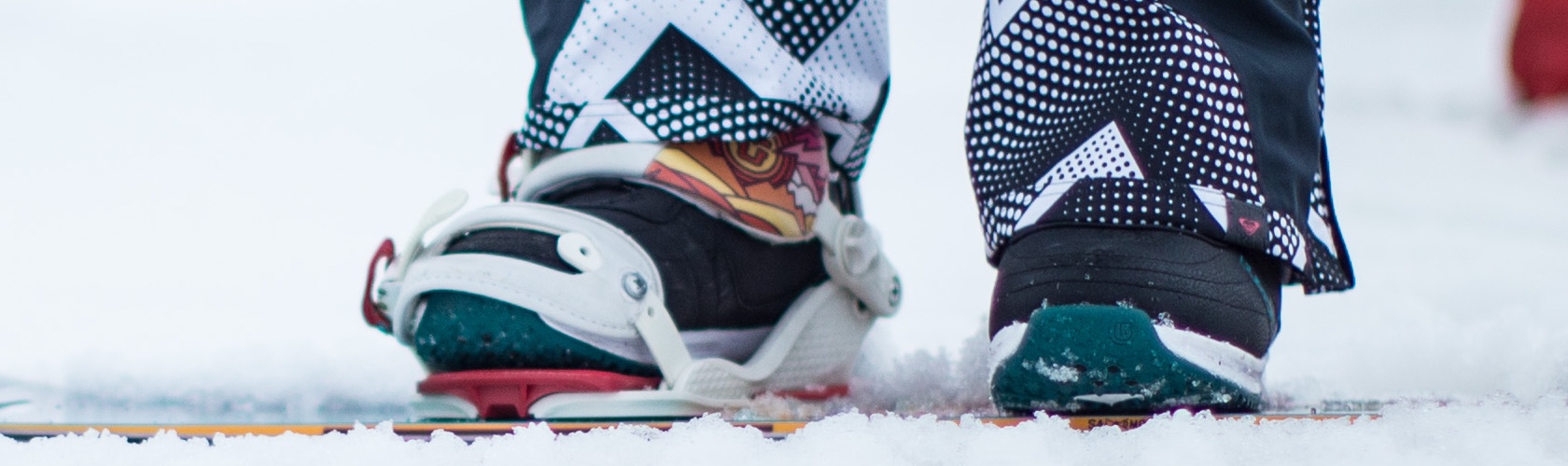 A person wearing snowboard boots in a binding